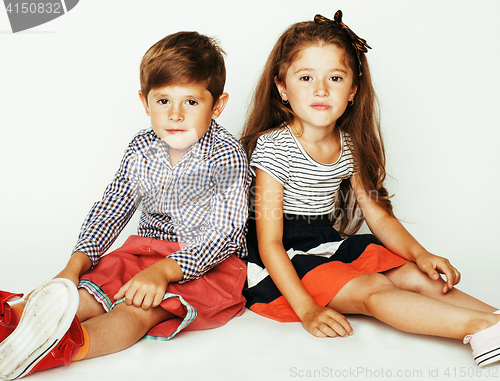 Image of little cute boy and girl hugging playing on white background, ha