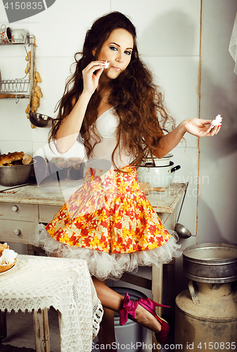 Image of crazy real woman housewife on kitchen, eating perfoming, bizare 