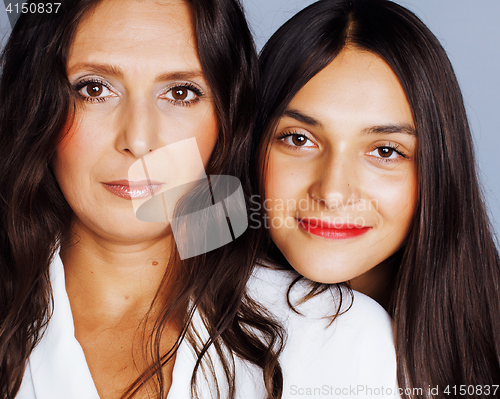 Image of cute pretty teen daughter with mature mother hugging, fashion st