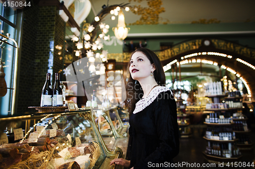 Image of young elegant brunette woman in cafe drinking coffee, luxury int