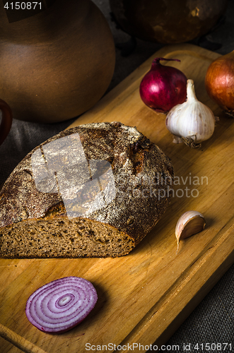 Image of Still life with homemade bread and pottery