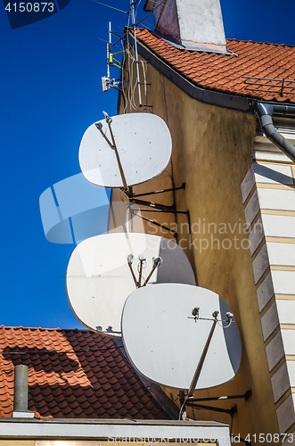 Image of Satellite dish on the roof of an old building