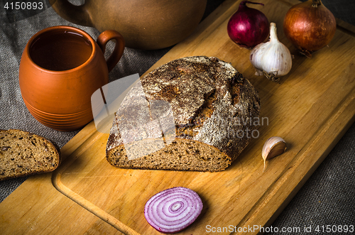 Image of Still life with homemade bread and pottery