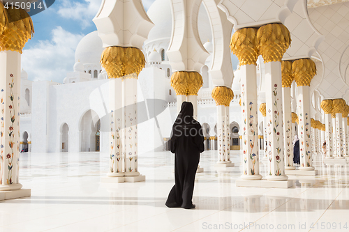 Image of Arabic woman in black burka in Sheikh Zayed Grand Mosque, Abu Dhabi, UAE.