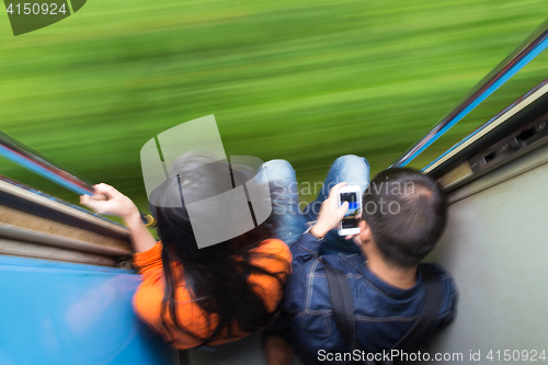 Image of Couple traveling by train. Motion blured image creating impression of movement and speed.