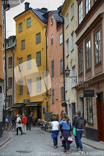 Image of STOCKHOLM, SWEDEN - AUGUST 19, 2016: View of narrow street and c