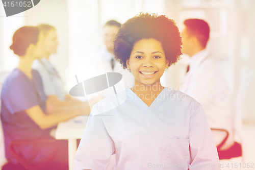 Image of happy doctor over group of medics at hospital