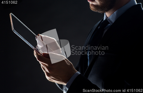 Image of close up of businessman with transparent tablet pc