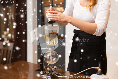 Image of close up of woman with siphon coffee maker and pot