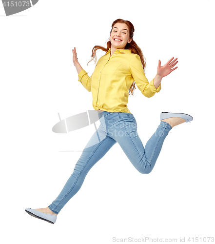 Image of smiling young woman jumping in air