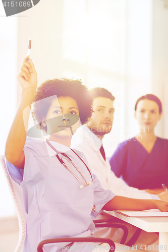 Image of group of happy doctors on conference at hospital