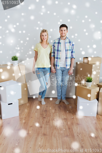 Image of smiling couple with big boxes moving to new home