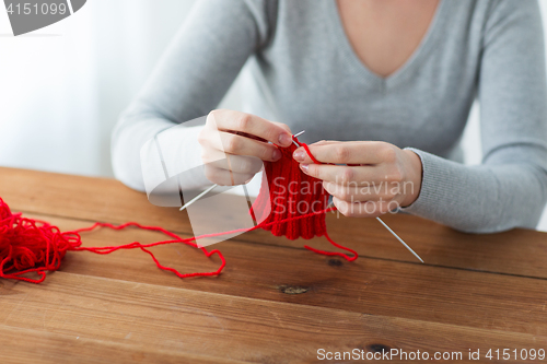 Image of woman hands knitting with needles and yarn