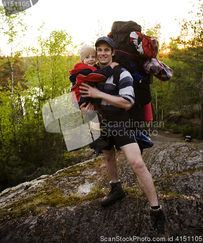 Image of young happy father traveling with little son and huge backpack, lifestyle people concept