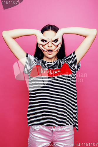 Image of young pretty teenage woman emotional posing on pink background, fashion lifestyle people concept