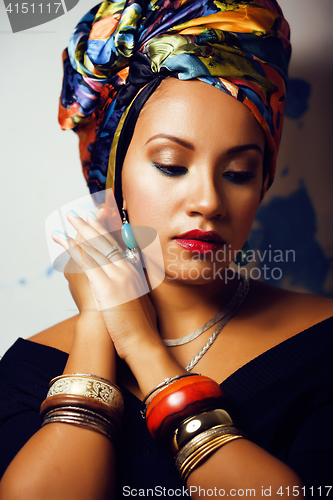 Image of beauty bright african woman with creative make up, shawl on head