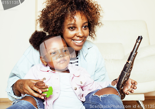 Image of adorable sweet young afro-american mother with cute little daughter, hanging at home, having fun playing smiling, lifestyle people concept, happy smiling modern family