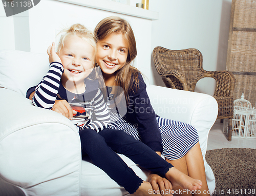 Image of two cute sisters at home interior playing, little happy smiling 