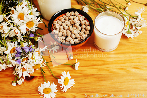 Image of Simply stylish wooden kitchen with bottle of milk and glass on t