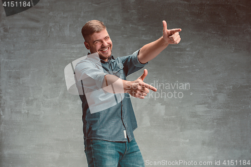 Image of Portrait of smiling happy man standing in studio