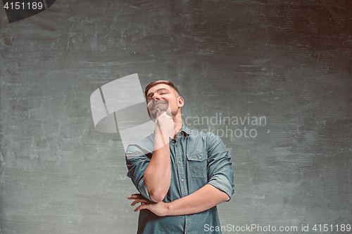 Image of Portrait of smiling happy man standing in studio