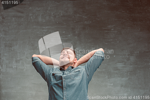 Image of Portrait of smiling happy man standing in studio