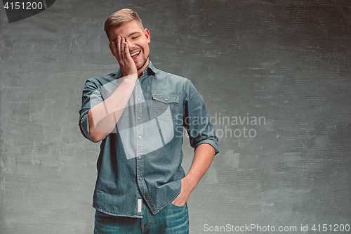 Image of Portrait of smiling happy man standing in studio