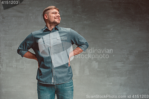 Image of Portrait of smiling happy man standing in studio