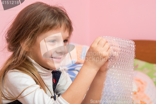 Image of Girl eats balls on the wrapping paper