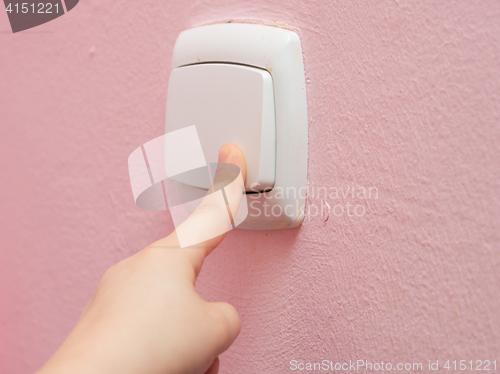 Image of Child\'s hand finger presses the switch, close-up