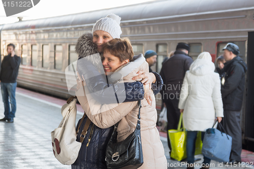 Image of Adult daughter met my mother at the train at the station