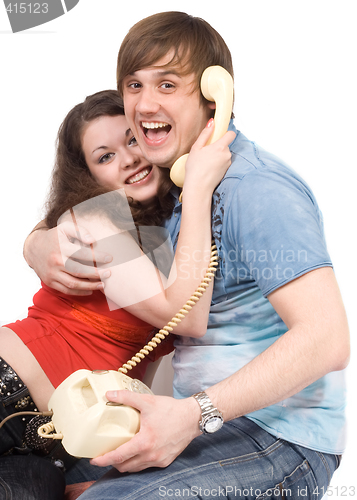 Image of The young couple with old phone. Funny picture. Isolated