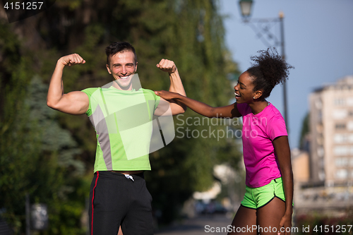 Image of portrait of young multietnic jogging couple ready to run