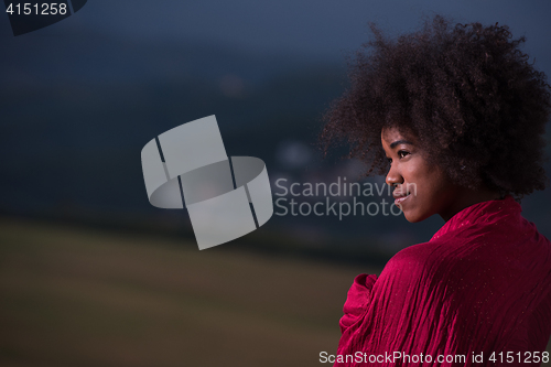 Image of outdoor portrait of a black woman with a scarf