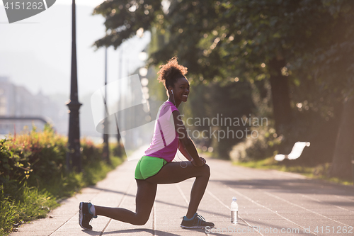 Image of Black woman doing warming up and stretching