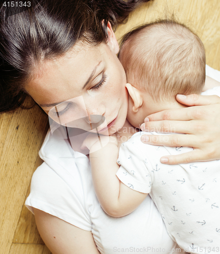 Image of young brunette happy mother holding toddler baby son, breast-feeding concept, lifestyle modern people