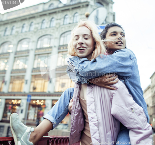 Image of Two teenage girls infront of university building smiling, having fun traveling europe, lifestyle people concept