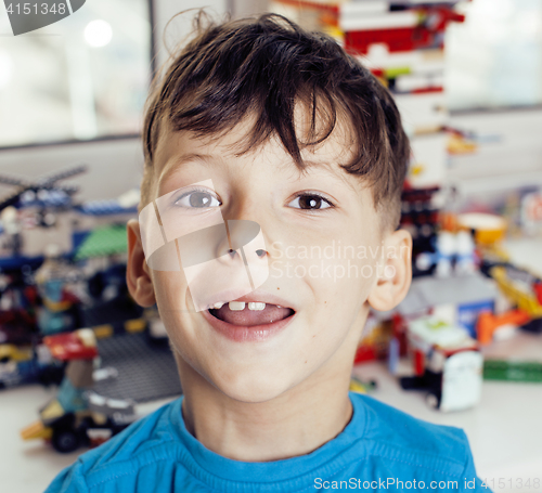 Image of little cute preschooler boy playing lego toys at home happy smiling, lifestyle children concept