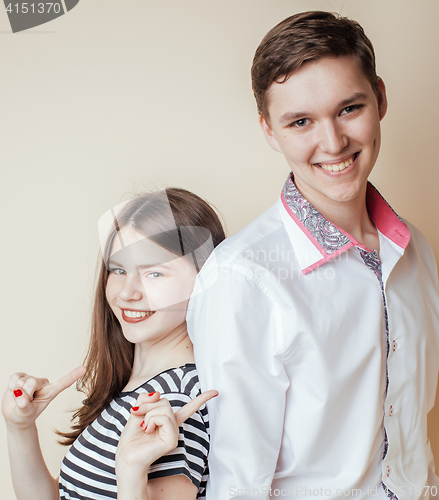 Image of couple of happy smiling teenagers students, warm colors having a kiss, lifestyle people concept, boy and girl together