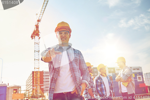 Image of builders pointing finger at you on construction