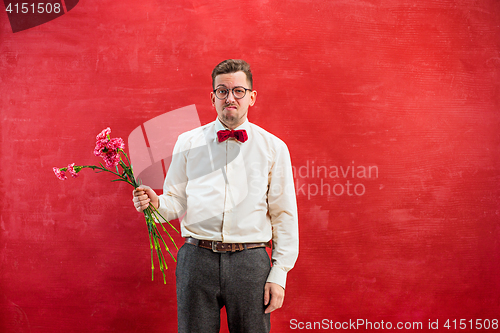 Image of Young beautiful man with flowers