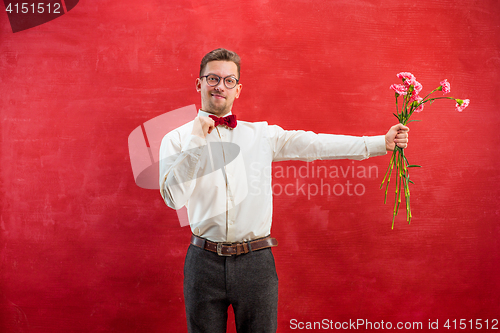 Image of Young beautiful man with flowers