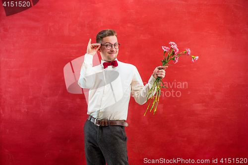 Image of Young beautiful man with flowers