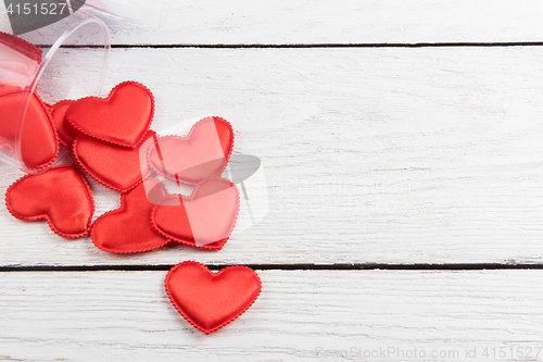 Image of Red hearts on a white wood background