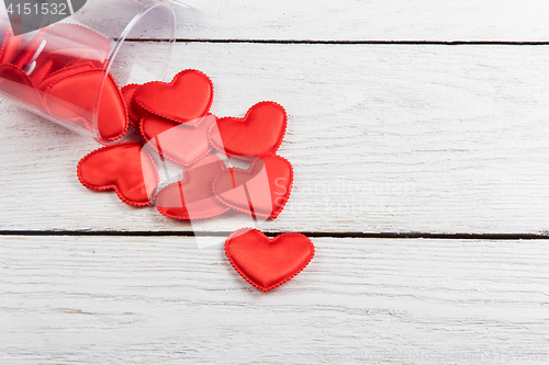 Image of Red hearts on a white wood background