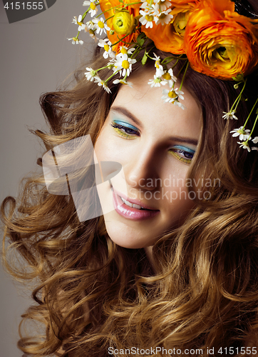 Image of Beauty young woman with flowers and make up close up, real sprin