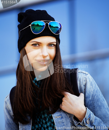 Image of young pretty girl near business building walking, student in ame