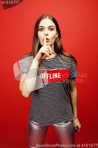 Image of young pretty emitonal posing teenage girl on bright red background, happy smiling lifestyle people concept