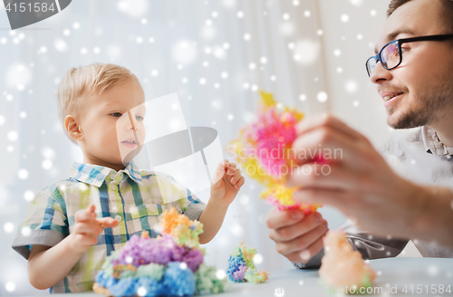 Image of father and son playing with ball clay at home