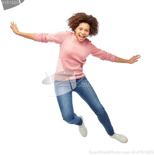 Image of happy african american woman jumping over white